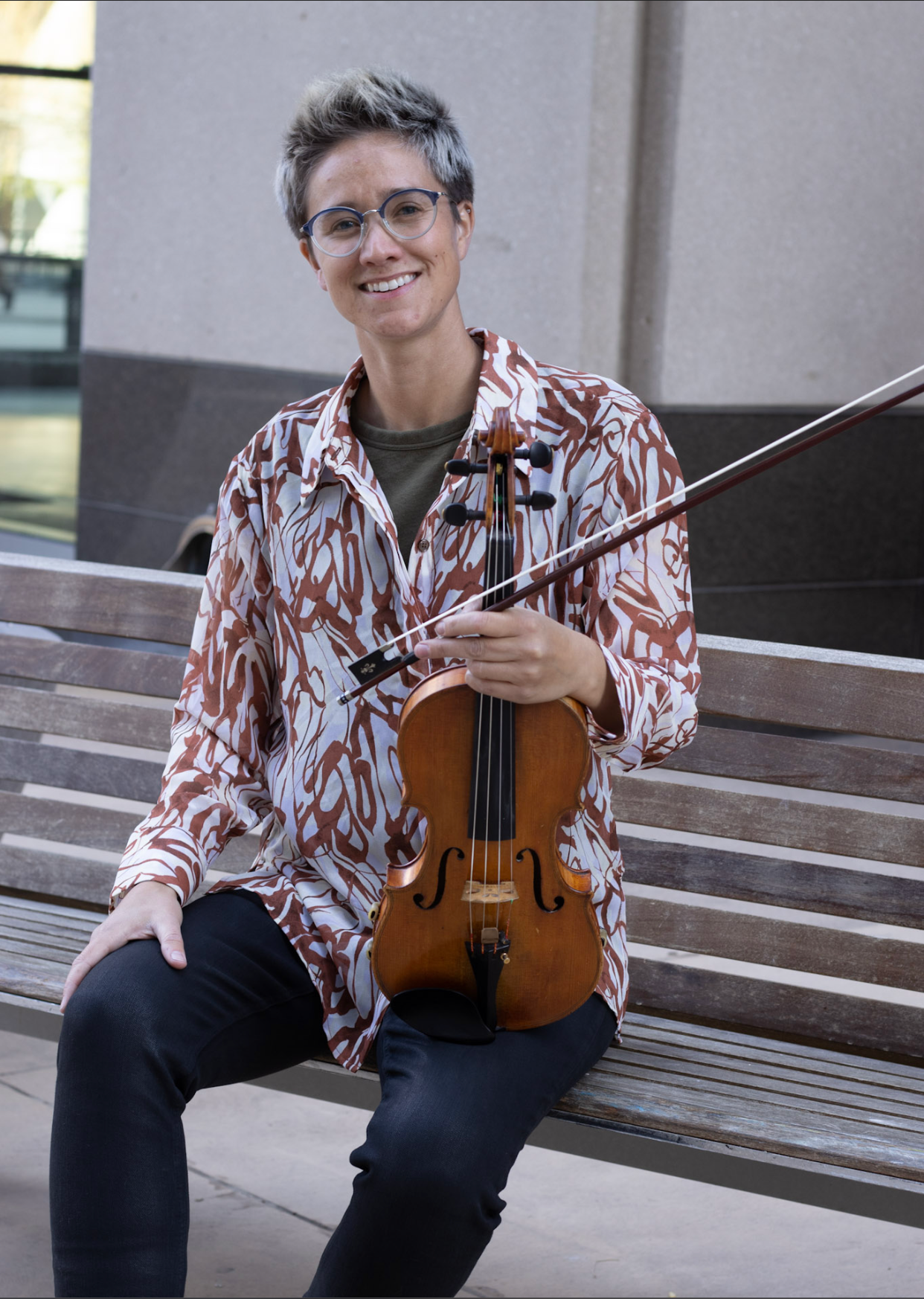 Violin instructor Rae holding violin